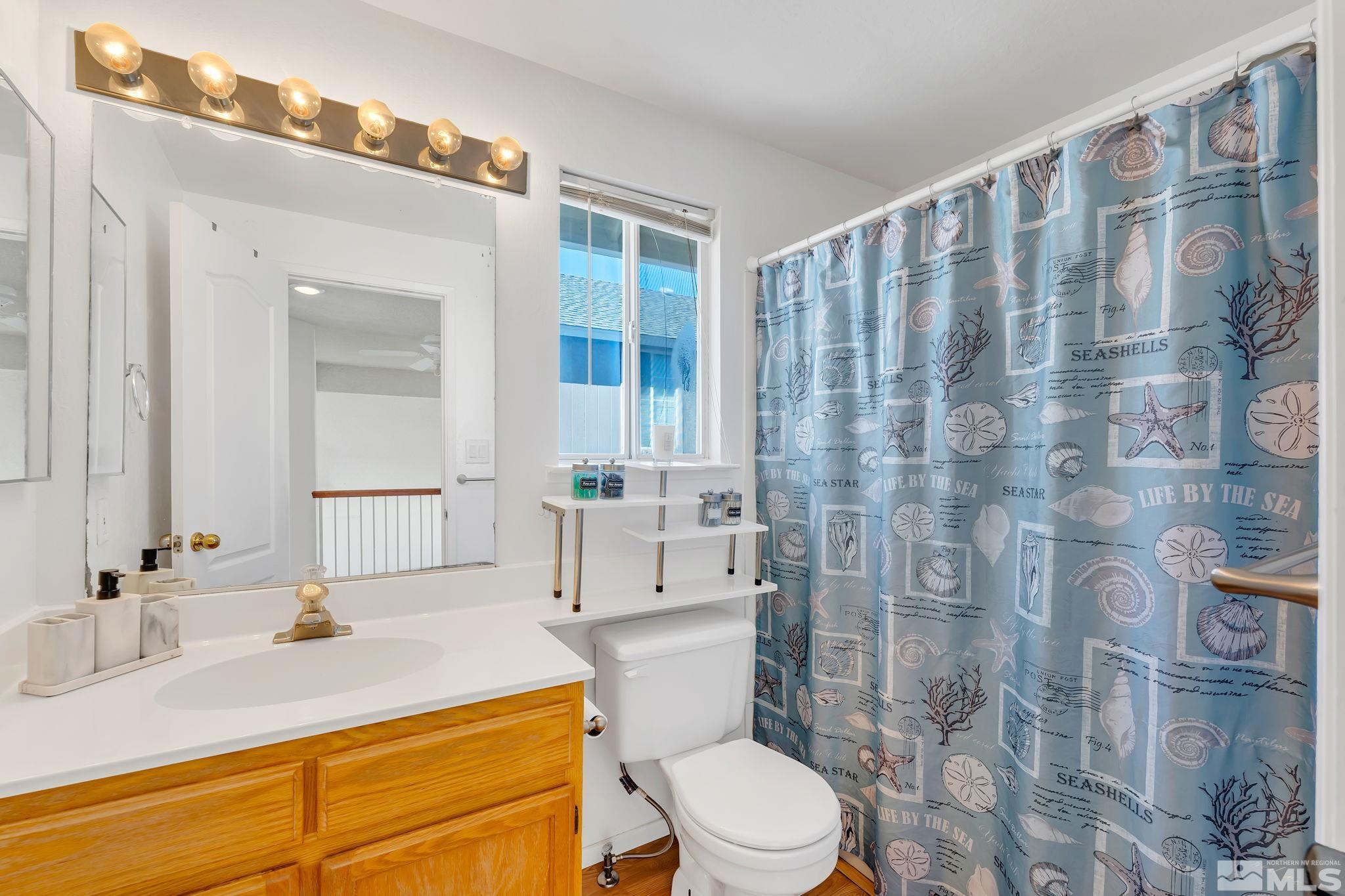 6580 Fall River Circle Reno, NV 89523 - Photo 29 of 36 a bathroom with a sink a toilet and shower