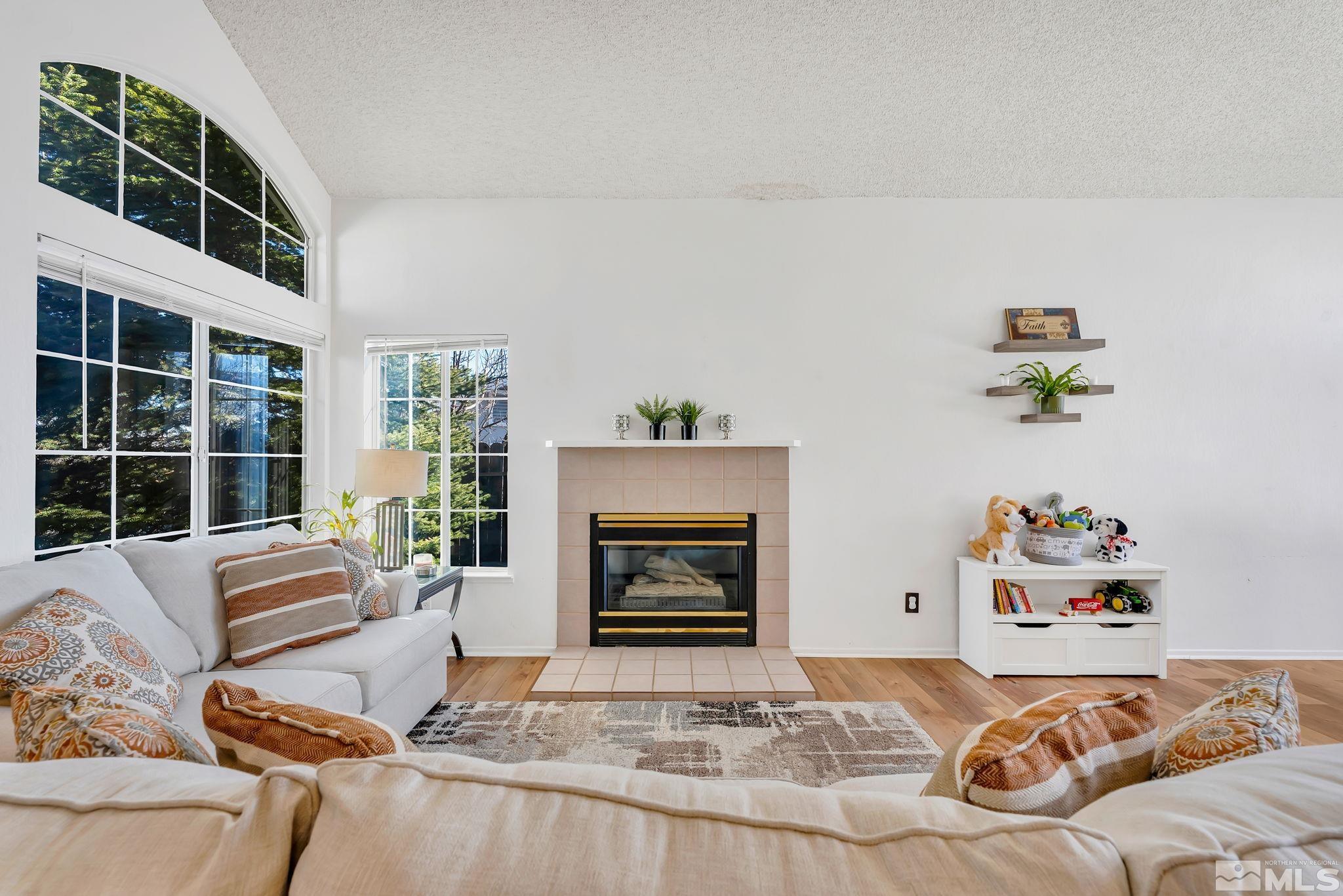 6580 Fall River Circle Reno, NV 89523 - Photo 6 of 36 a living room with furniture and a fireplace