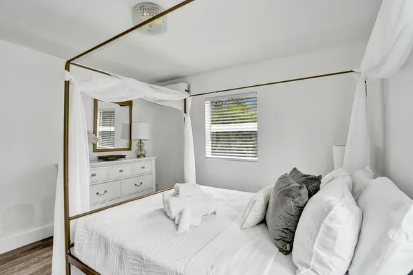 a bedroom with a bed and a window
