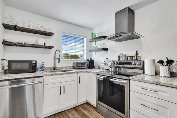a kitchen with a stove a sink and a refrigerator