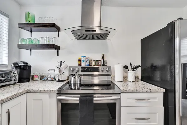 a kitchen with cabinets and stainless steel appliances