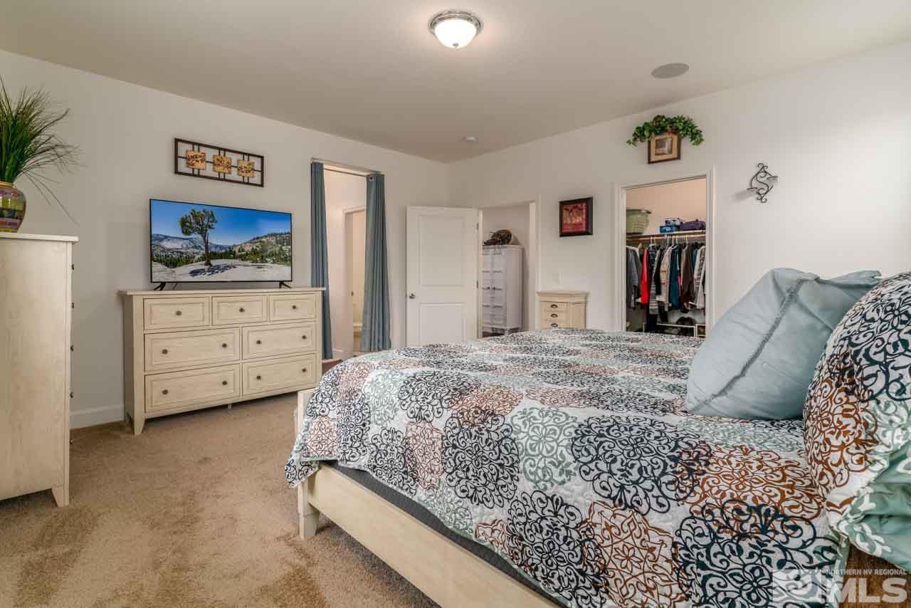 9341 Pond Court Reno, NV 89506 - Photo 15 of 30 a bed room with a bed and a television