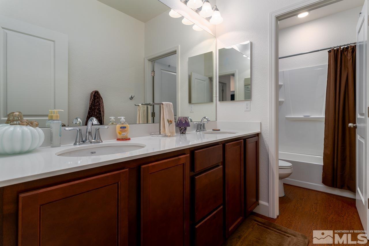 9341 Pond Court Reno, NV 89506 - Photo 19 of 30 a bathroom with a double vanity sink and a mirror
