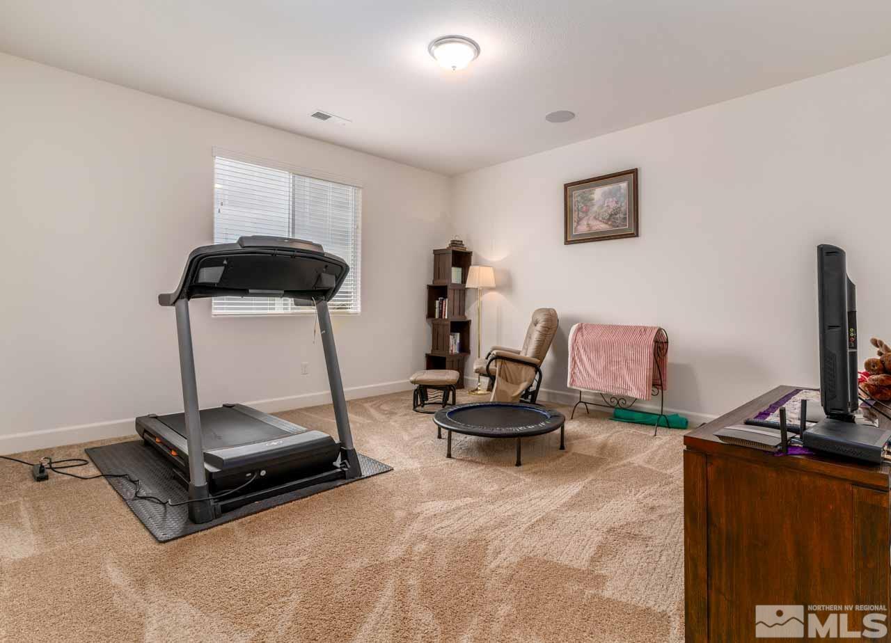 9341 Pond Court Reno, NV 89506 - Photo 20 of 30 a room with gym equipment and a flat screen tv