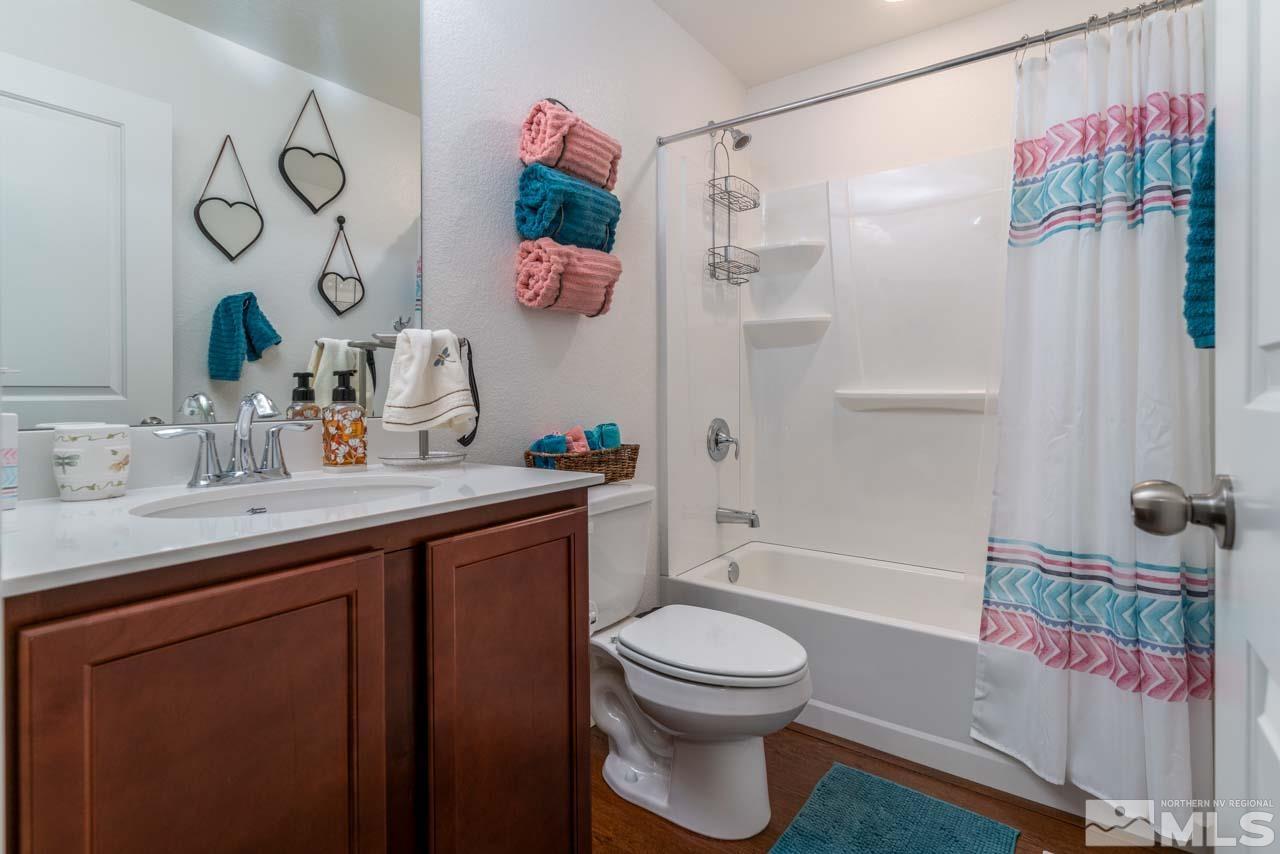 9341 Pond Court Reno, NV 89506 - Photo 22 of 30 a bathroom with a sink a toilet and shower