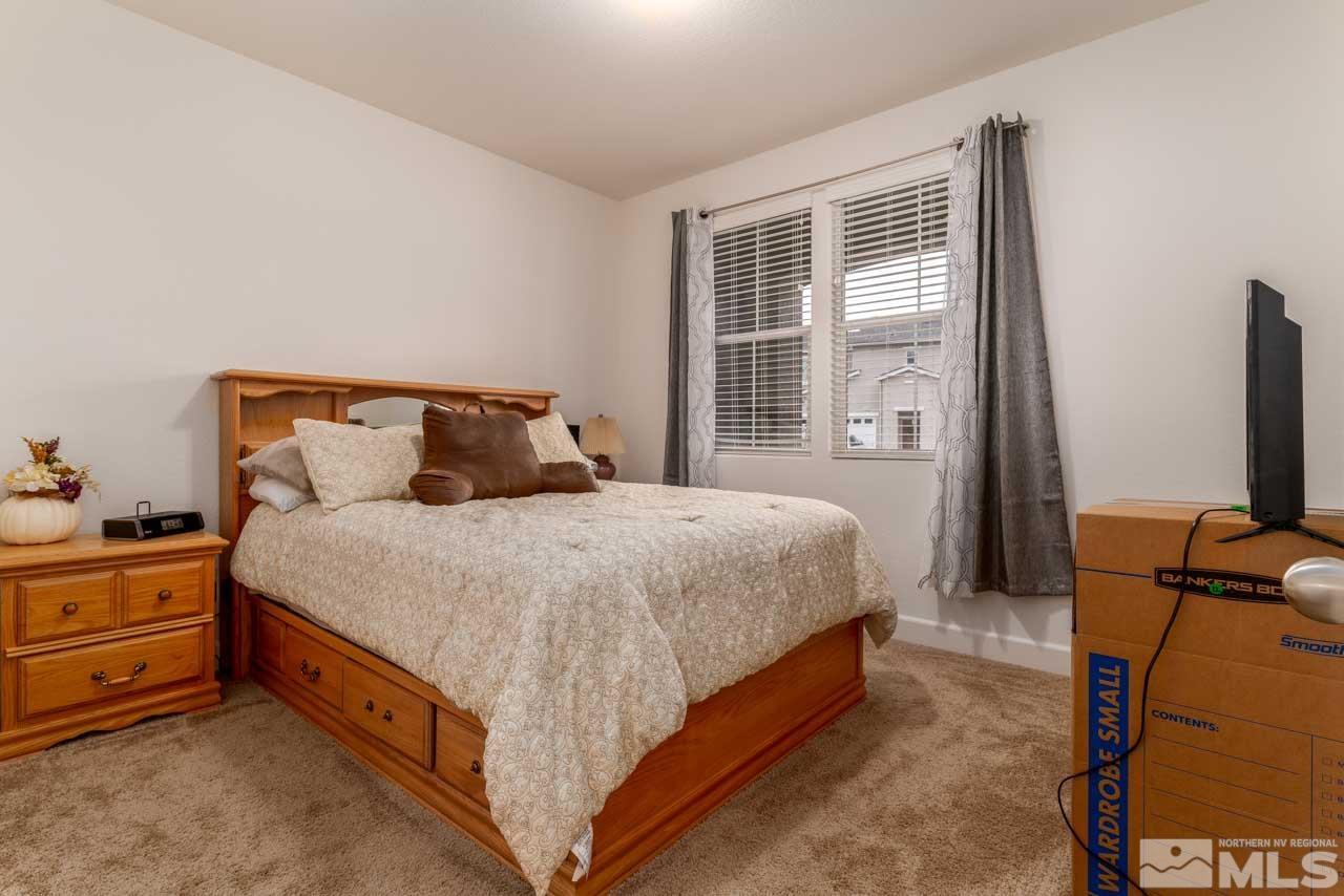 9341 Pond Court Reno, NV 89506 - Photo 23 of 30 a bed sitting in a bedroom next to a window