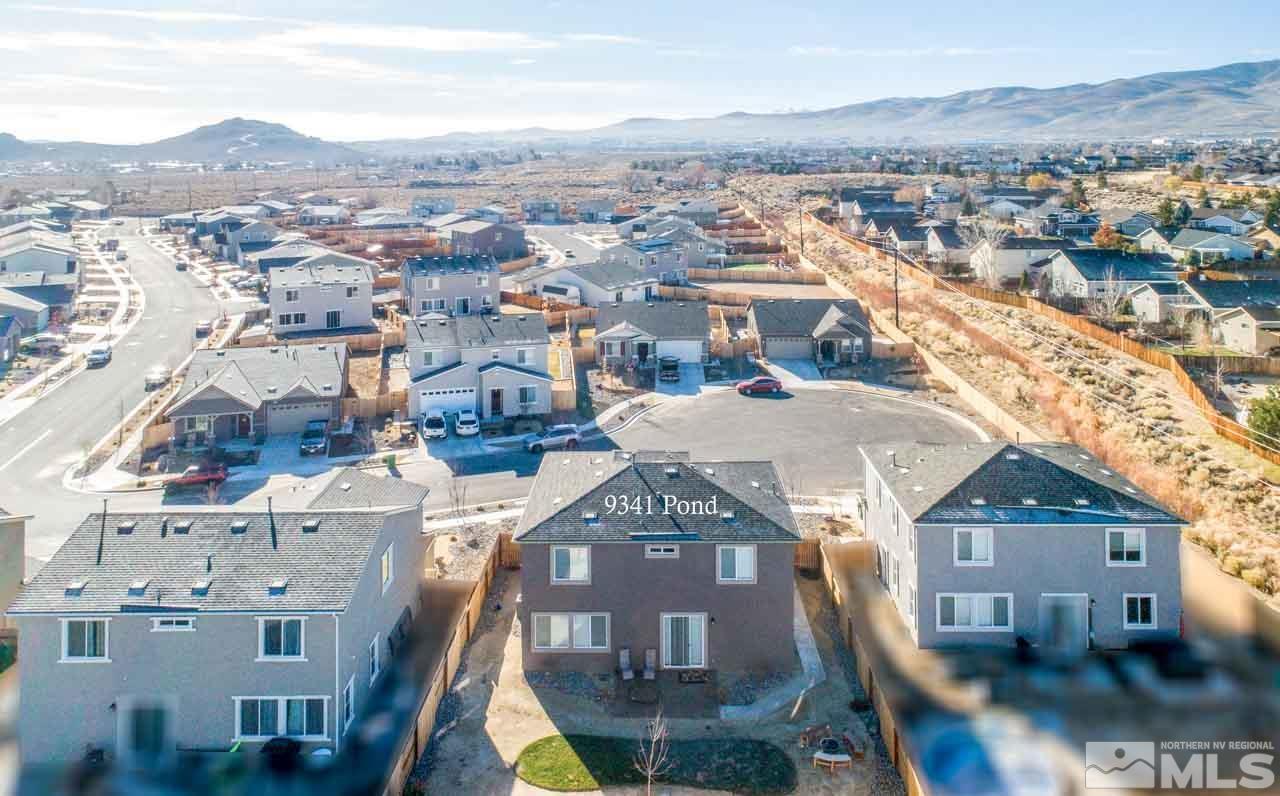 9341 Pond Court Reno, NV 89506 - Photo 4 of 30 an aerial view of a residential apartment building in front of a yard