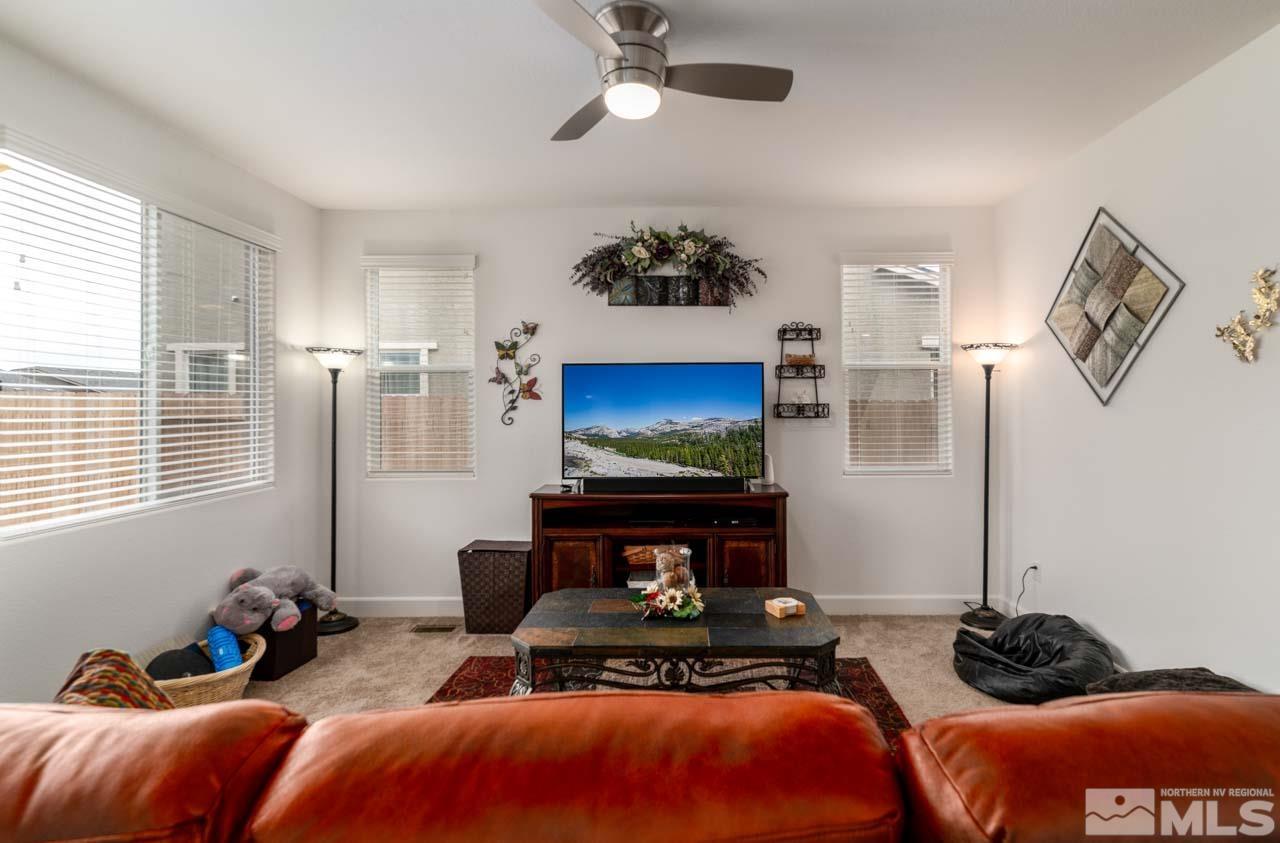 9341 Pond Court Reno, NV 89506 - Photo 6 of 30 a bedroom with furniture and a fireplace