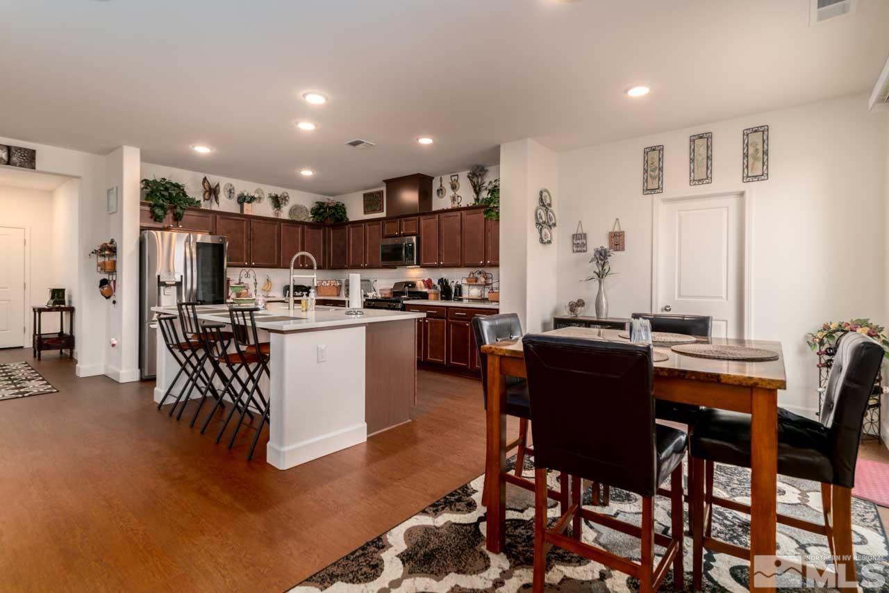 9341 Pond Court Reno, NV 89506 - Photo 8 of 30 a kitchen with stainless steel appliances kitchen island granite countertop a table and chairs
