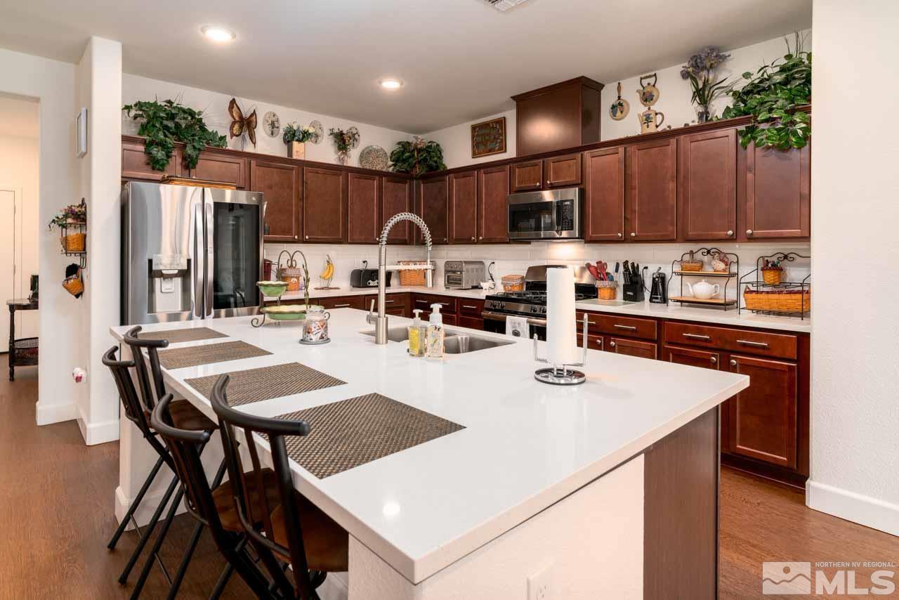 9341 Pond Court Reno, NV 89506 - Photo 10 of 30 a kitchen with a dining table and chairs