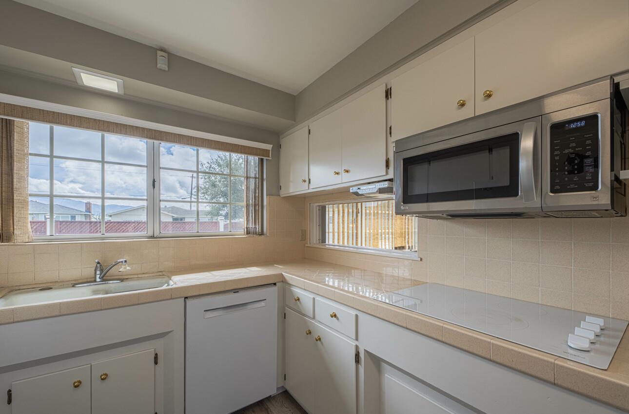 607 La Mesa Drive Salinas, CA 93901 - Photo 13 of 34 a kitchen with stainless steel appliances white cabinets and a sink