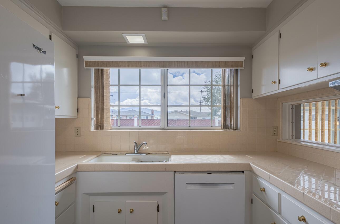 607 La Mesa Drive Salinas, CA 93901 - Photo 14 of 34 a kitchen with a sink cabinets appliances and a window