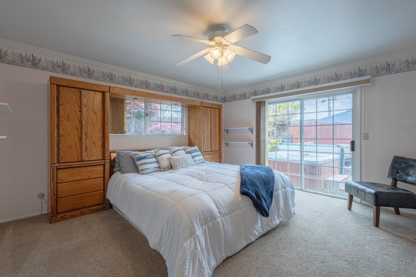 607 La Mesa Drive Salinas, CA 93901 - Photo 17 of 34 a bedroom with a bed and a chandelier
