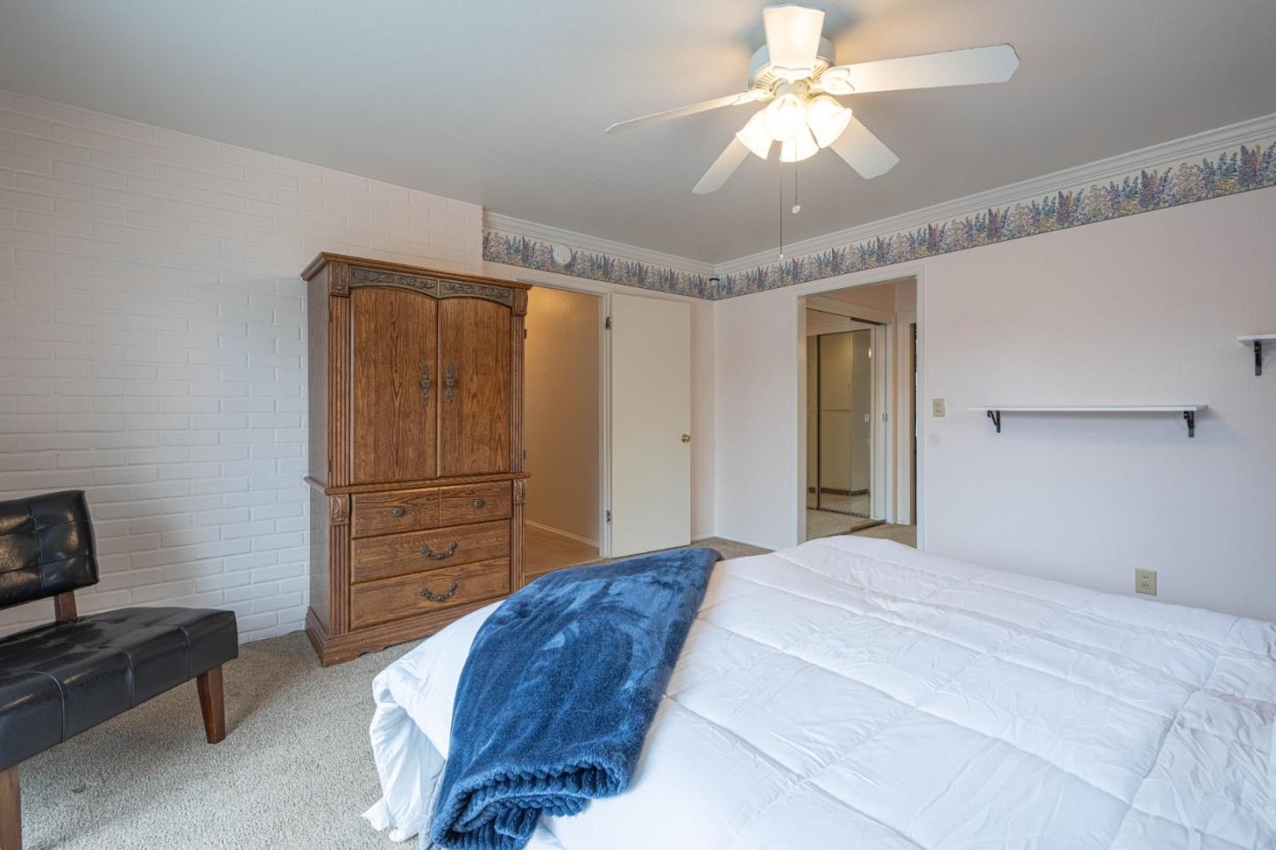 607 La Mesa Drive Salinas, CA 93901 - Photo 18 of 34 a bedroom with a bed and a chandelier