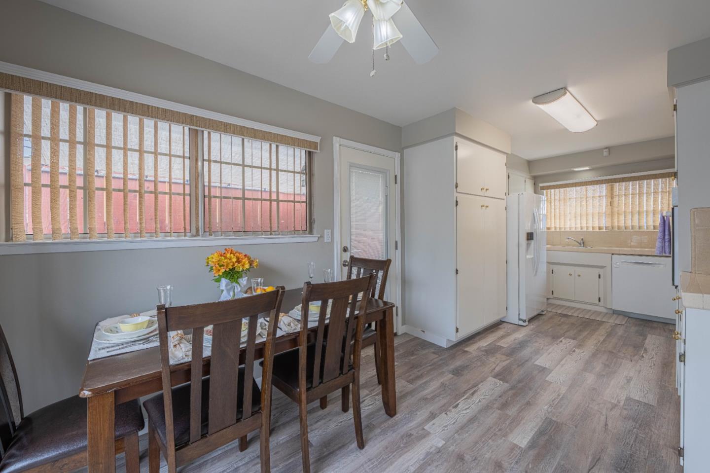 607 La Mesa Drive Salinas, CA 93901 - Photo 10 of 34 a kitchen that has a table chairs in it wooden floors and white walls