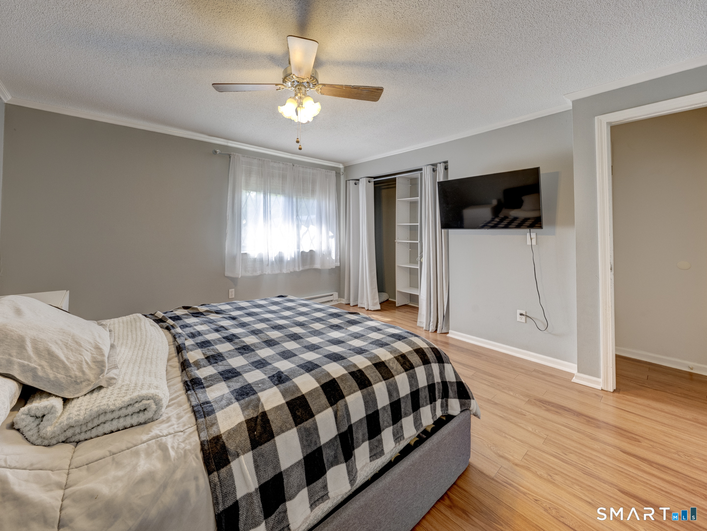 2 Branch Road, Unit 2C Thomaston, CT 06787 - Photo 15 of 26 a bedroom with a bed and a flat screen tv