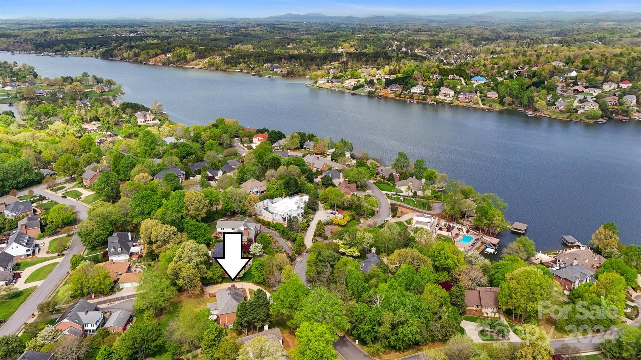 an aerial view of a houses with a lake view