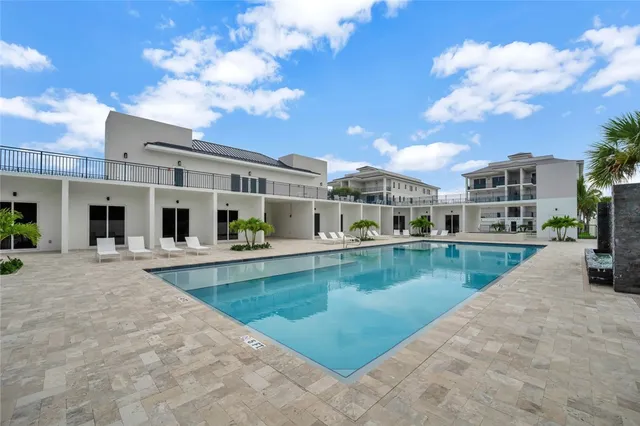 a view of a swimming pool and lounge chair