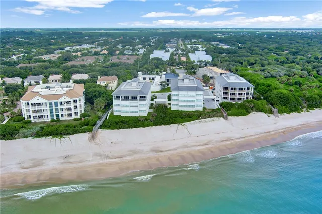 an aerial view of residential houses with city view