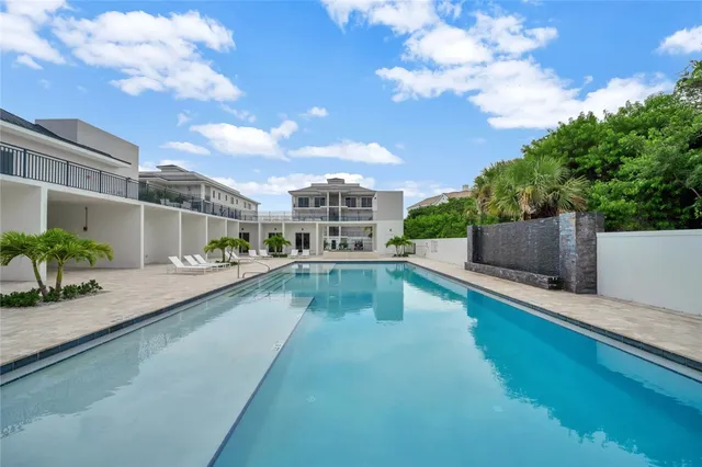 a view of a swimming pool with a lounge chair