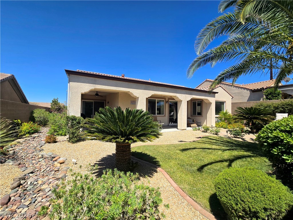 2567 Dirleton Place Henderson, NV 89044 - Photo 59 of 67 Lush landscaping and a covered patio enhance this inviting outdoor retreat.