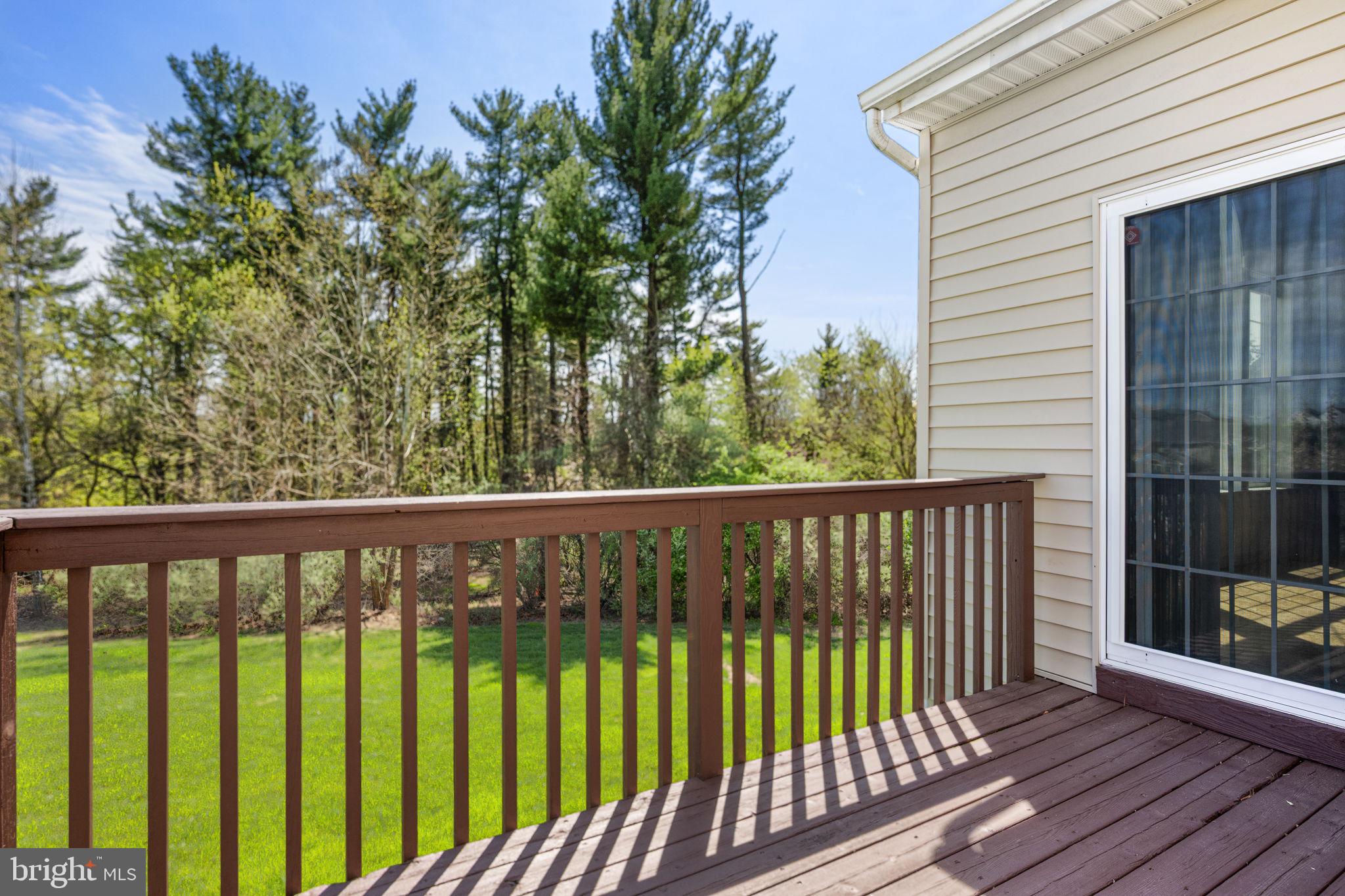 1417 Stockton Road Coatesville, PA 19320 - Photo 32 of 39 Serene deck with lush green backdrop.