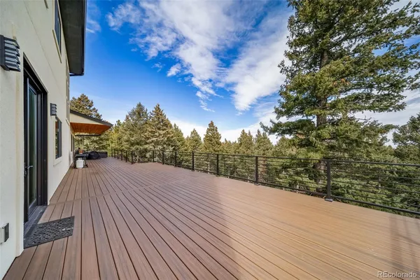 a view of balcony with wooden floor and fence