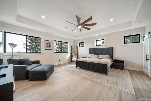 a bedroom with a large bed and a flat screen tv