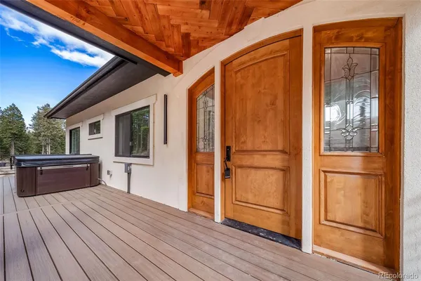 a view of a balcony with furniture and wooden floor