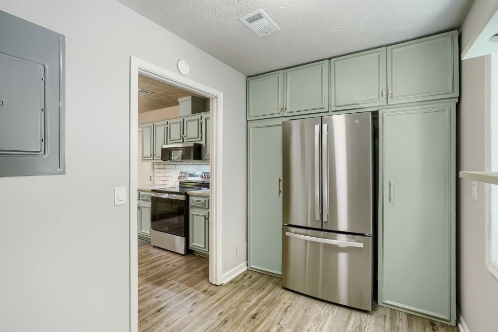 2021 Irwin Bridge Road Northwest Conyers, GA 30012 - Photo 17 of 43 a kitchen with stainless steel appliances a refrigerator and a stove top oven