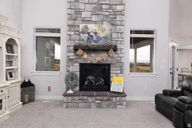 186 West 580 North Redmond, UT 84652 - Photo 11 of 74 Carpeted living room featuring a high ceiling and a fireplace