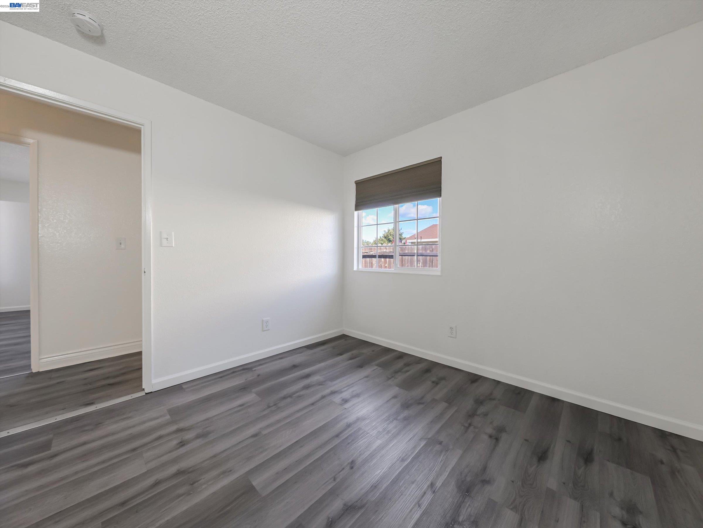 3432 Danielle Place Bay Point, CA 94565 - Photo 28 of 36 an empty room with wooden floor and windows