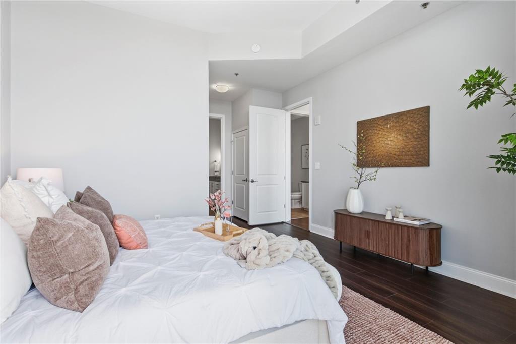270 17th Street Northwest, Unit 4306 Atlanta, GA 30363 - Photo 23 of 37 a bedroom with a bed and couch