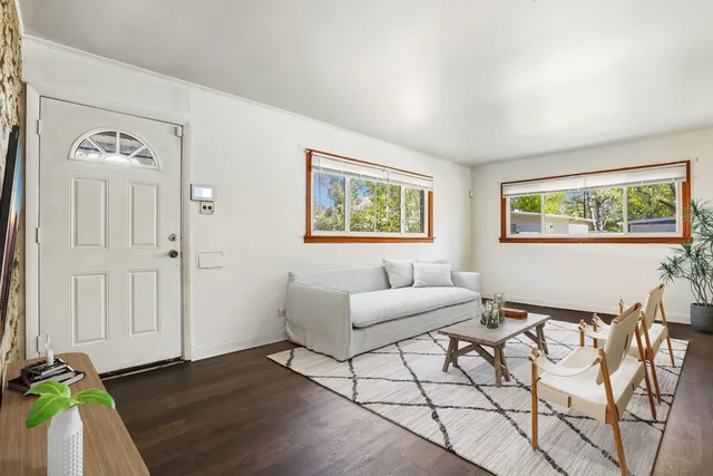a living room with furniture and wooden floor