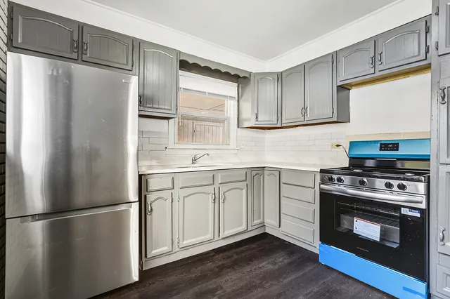 a kitchen with a refrigerator stove and sink
