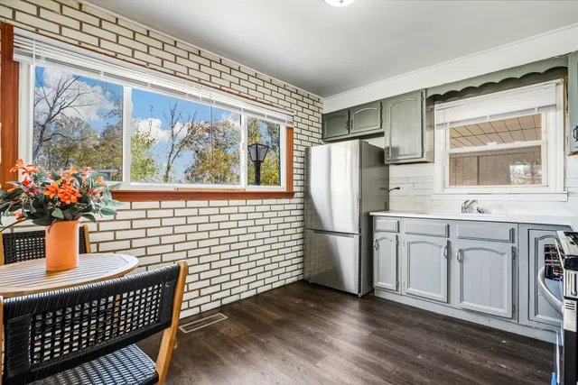 a kitchen with stainless steel appliances a refrigerator and a stove top oven