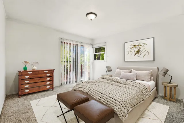 a bedroom with a bed and cabinets