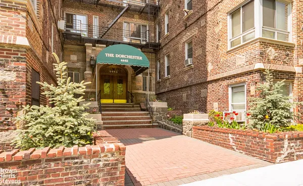 a view of a brick building with many windows