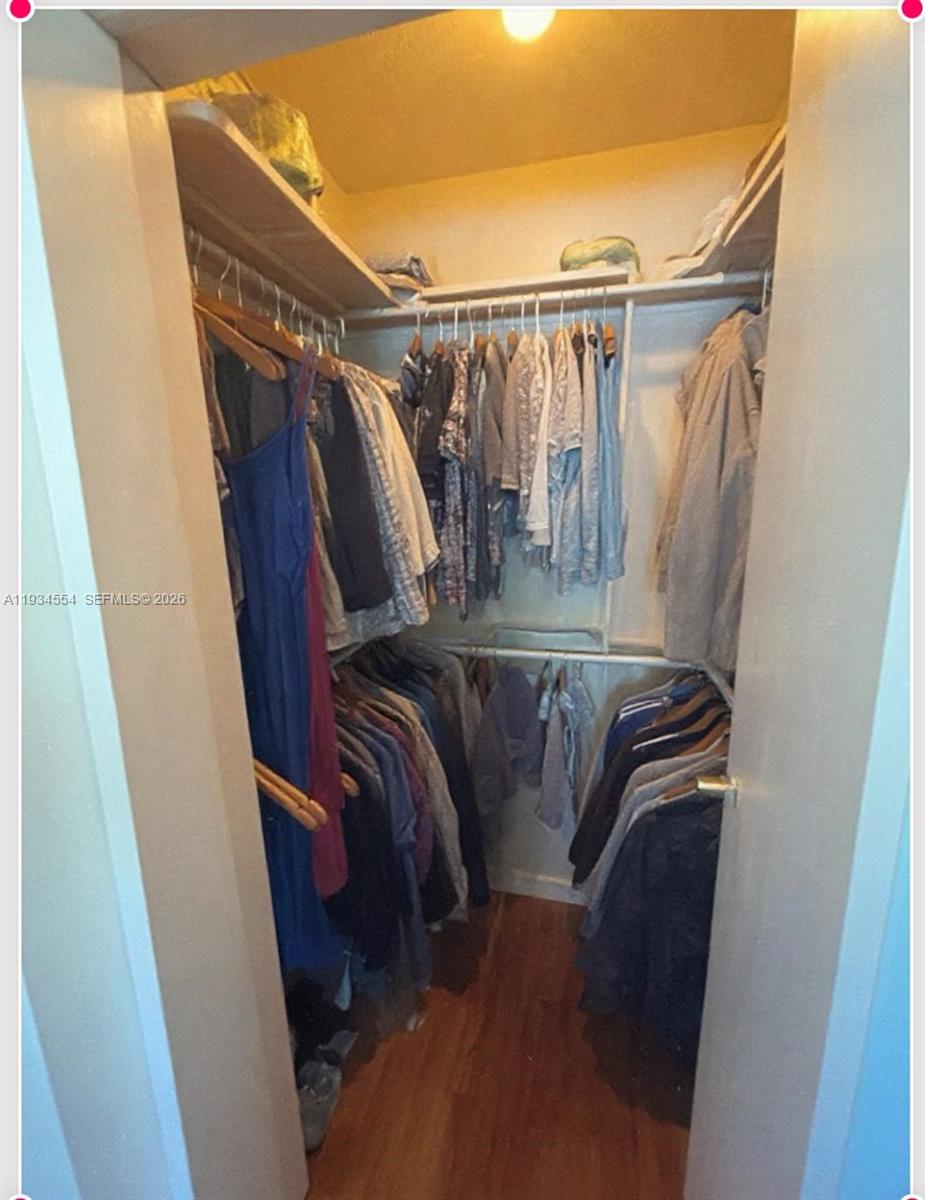 630 Northeast 165th Street Miami, FL 33162 - Photo 21 of 36 a view of walk in closet with clothes and shoes