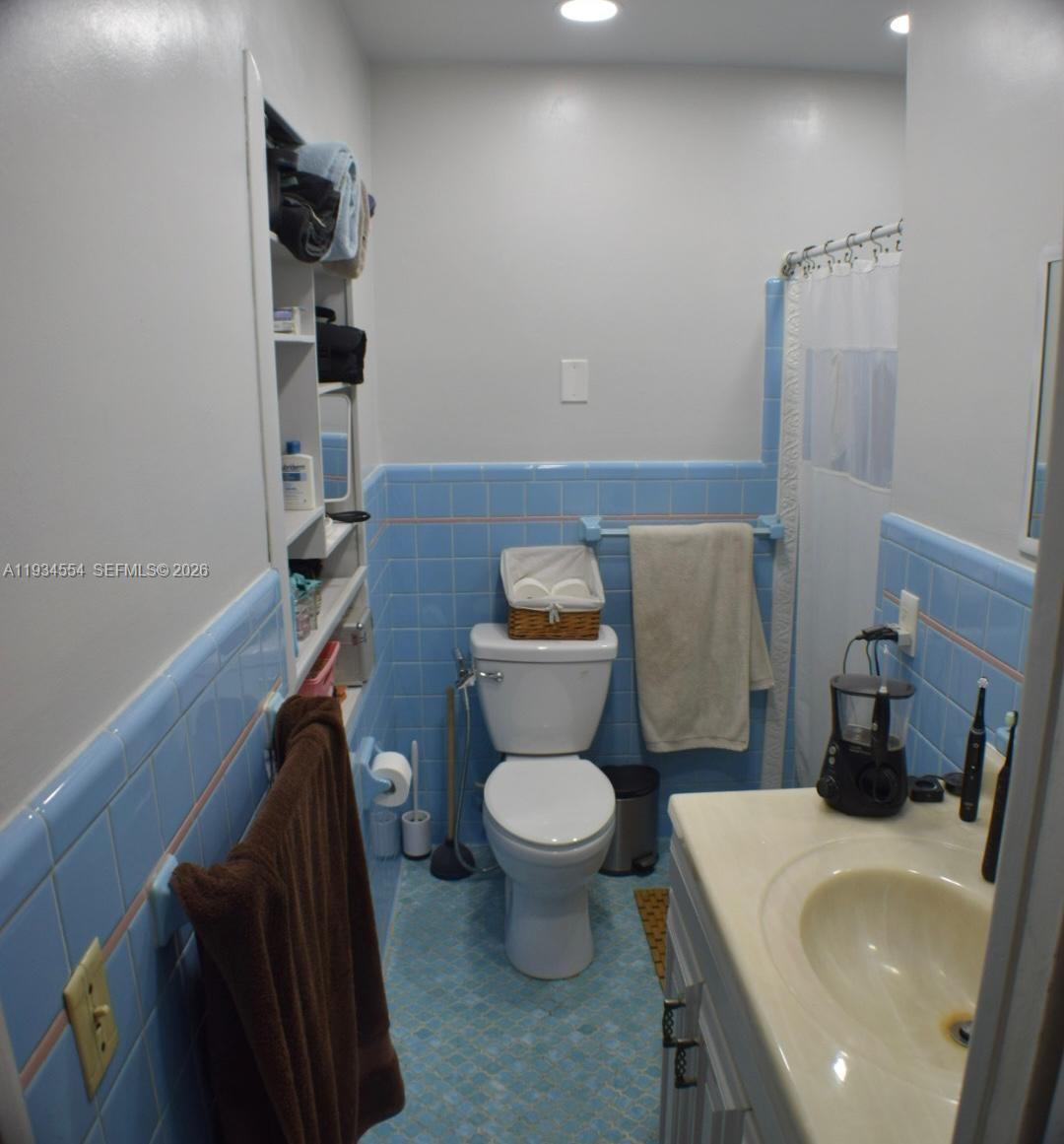630 Northeast 165th Street Miami, FL 33162 - Photo 27 of 36 a bathroom with a toilet and a sink