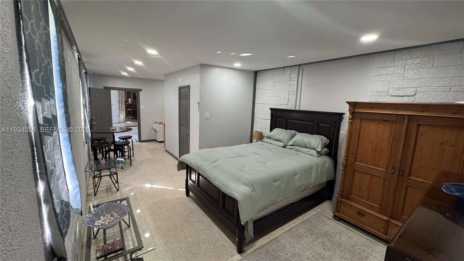 630 Northeast 165th Street Miami, FL 33162 - Photo 31 of 34 a bed room with a bed and a refrigerator