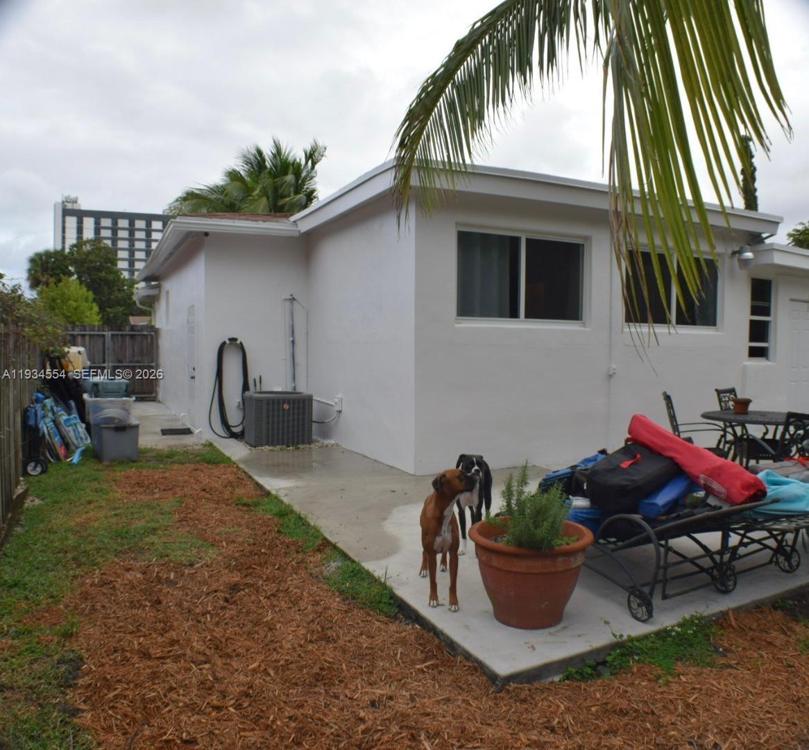 630 Northeast 165th Street Miami, FL 33162 - Photo 5 of 34 a backyard of a house with seating space