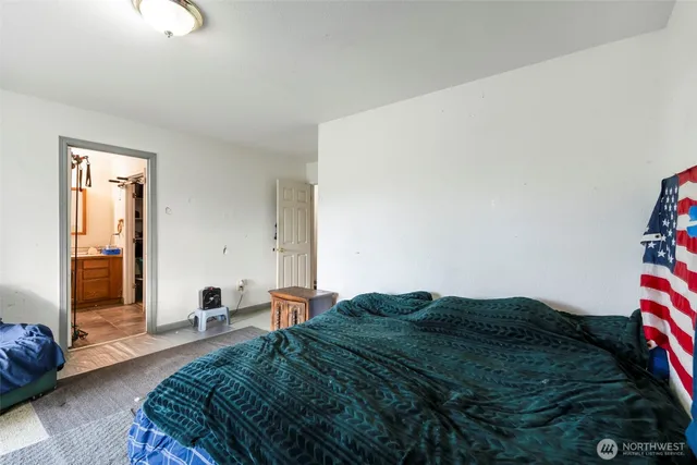 a bed sitting in a bedroom next to a window