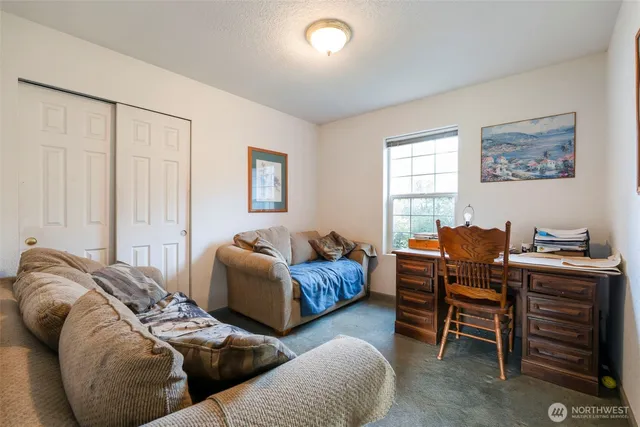 a bedroom with furniture and a window