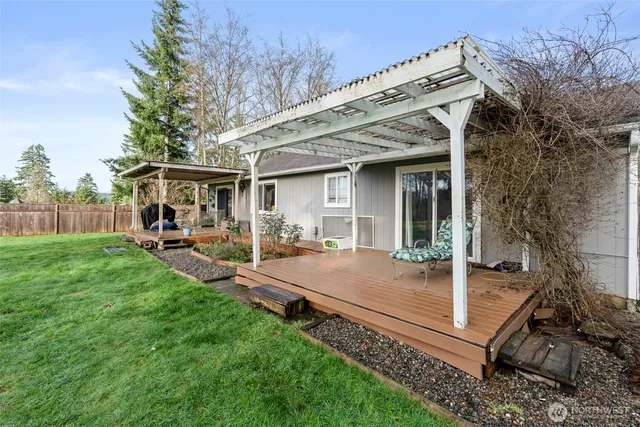 a view of a house with backyard porch and sitting area