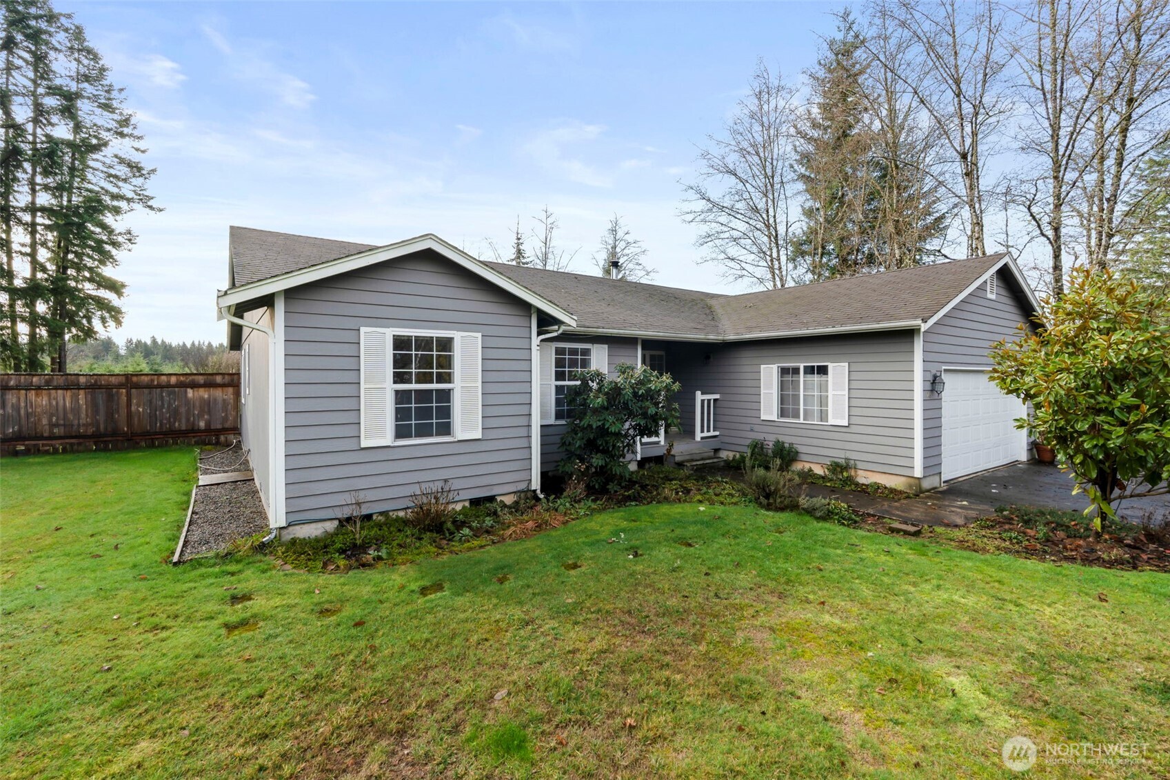 126 Bethany Lane Winlock, WA 98596 - Photo 26 of 37 a view of a house with a yard potted plants and a large tree