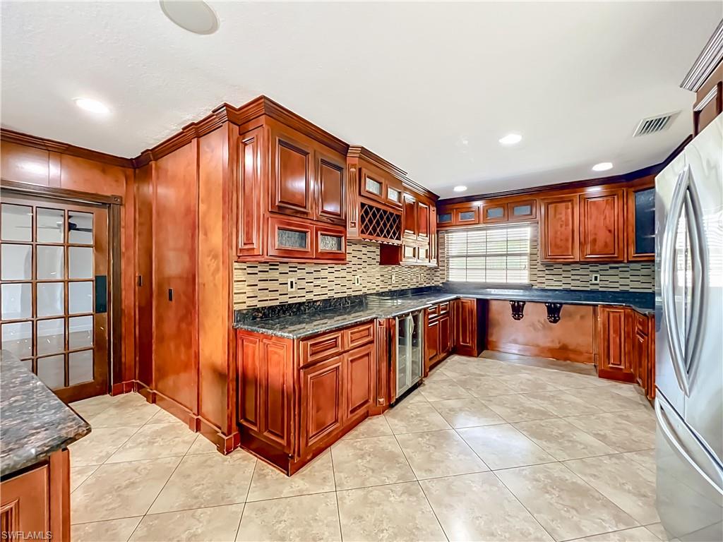 4210 South Hiawassee Road Orlando, FL 32835 - Photo 17 of 49 a kitchen with stainless steel appliances granite countertop a stove and large cabinets