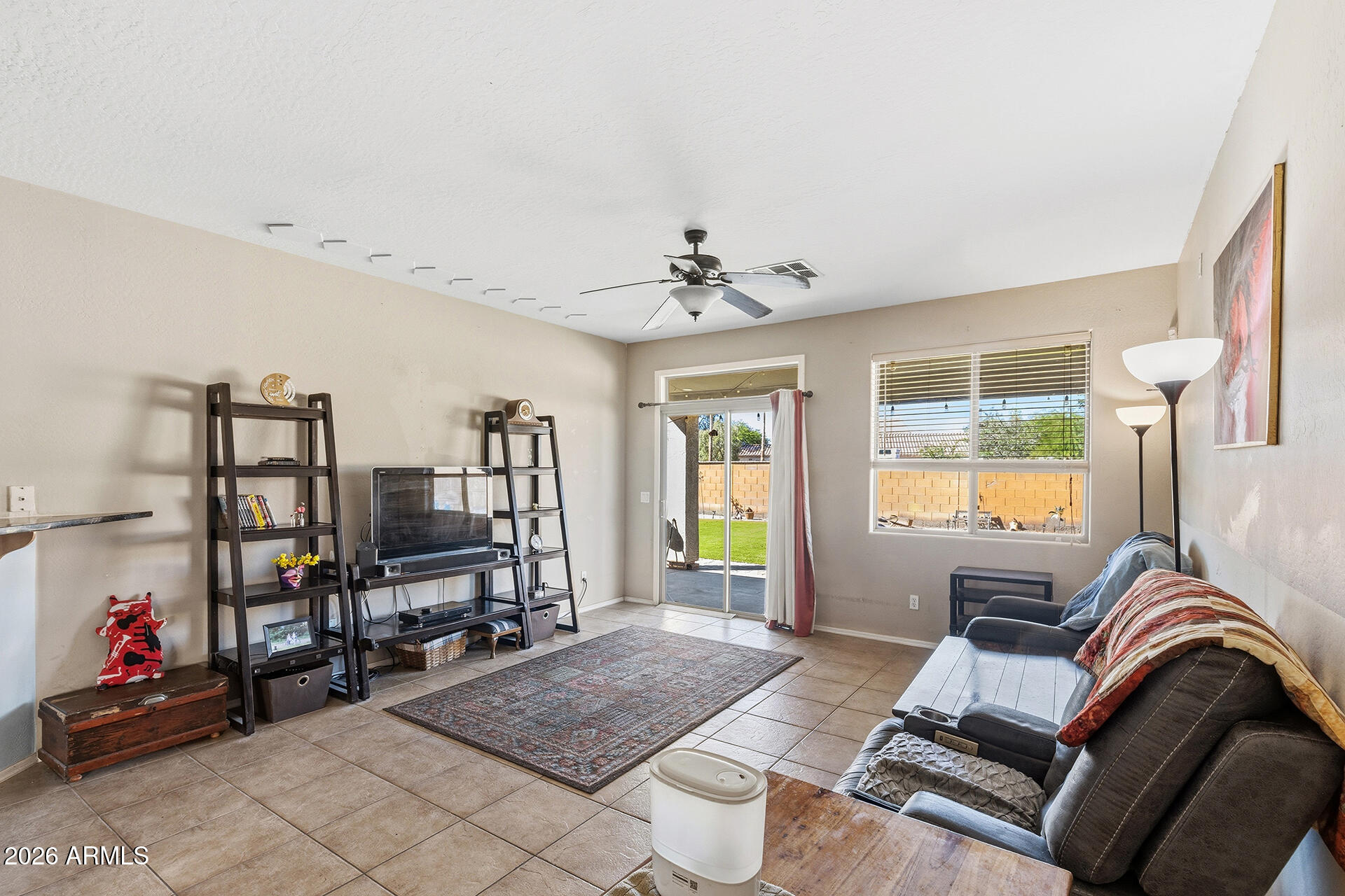 6718 West Darrel Road Laveen, AZ 85339 - Photo 38 of 49 a living room with furniture and a flat screen tv