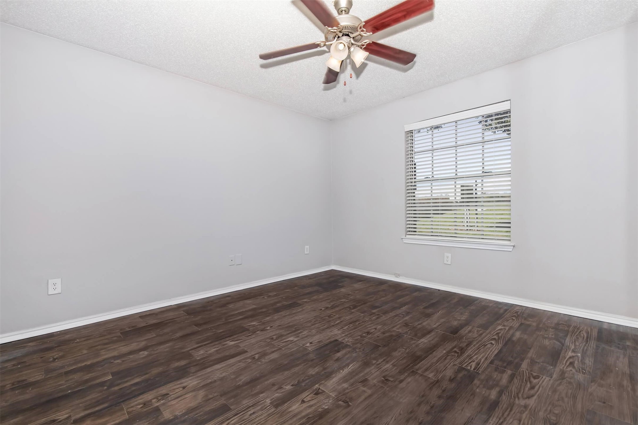 8301 Boat Club Road, Unit 721 Fort Worth, TX 76179 - Photo 7 of 44 an empty room with wooden floor fan and windows