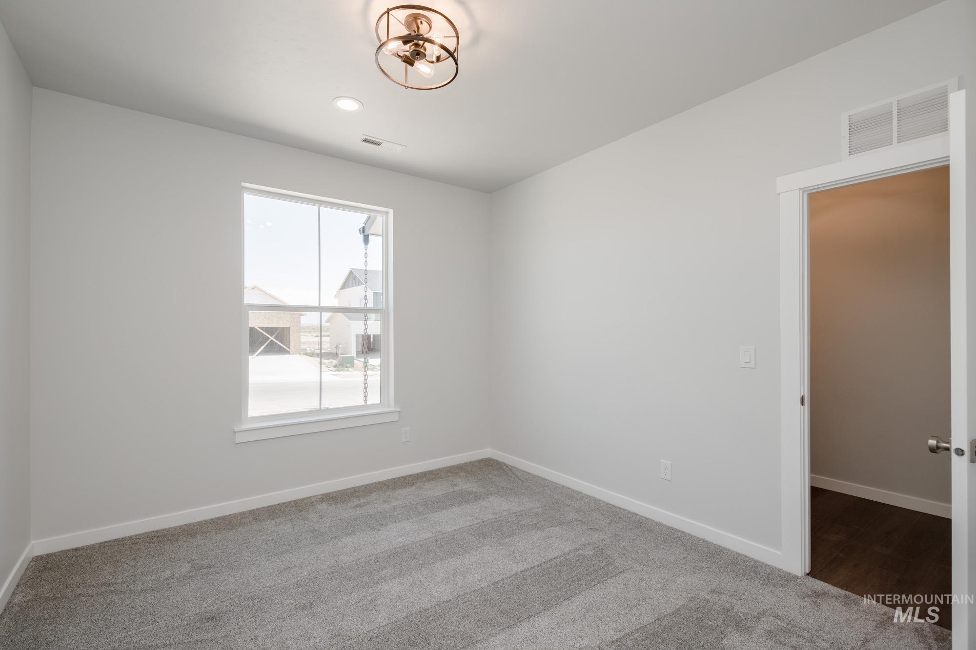 6447 South Sunfish Way Boise, ID 83709 - Photo 15 of 29 Carpeted empty room with baseboards and recessed lighting